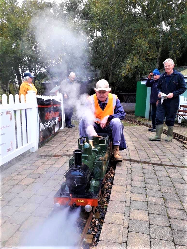 A Manx Steam and Model Engineering Club member operating a mini steam locomotive
